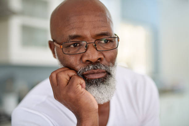 shot of a mature man looking thoughtful at home